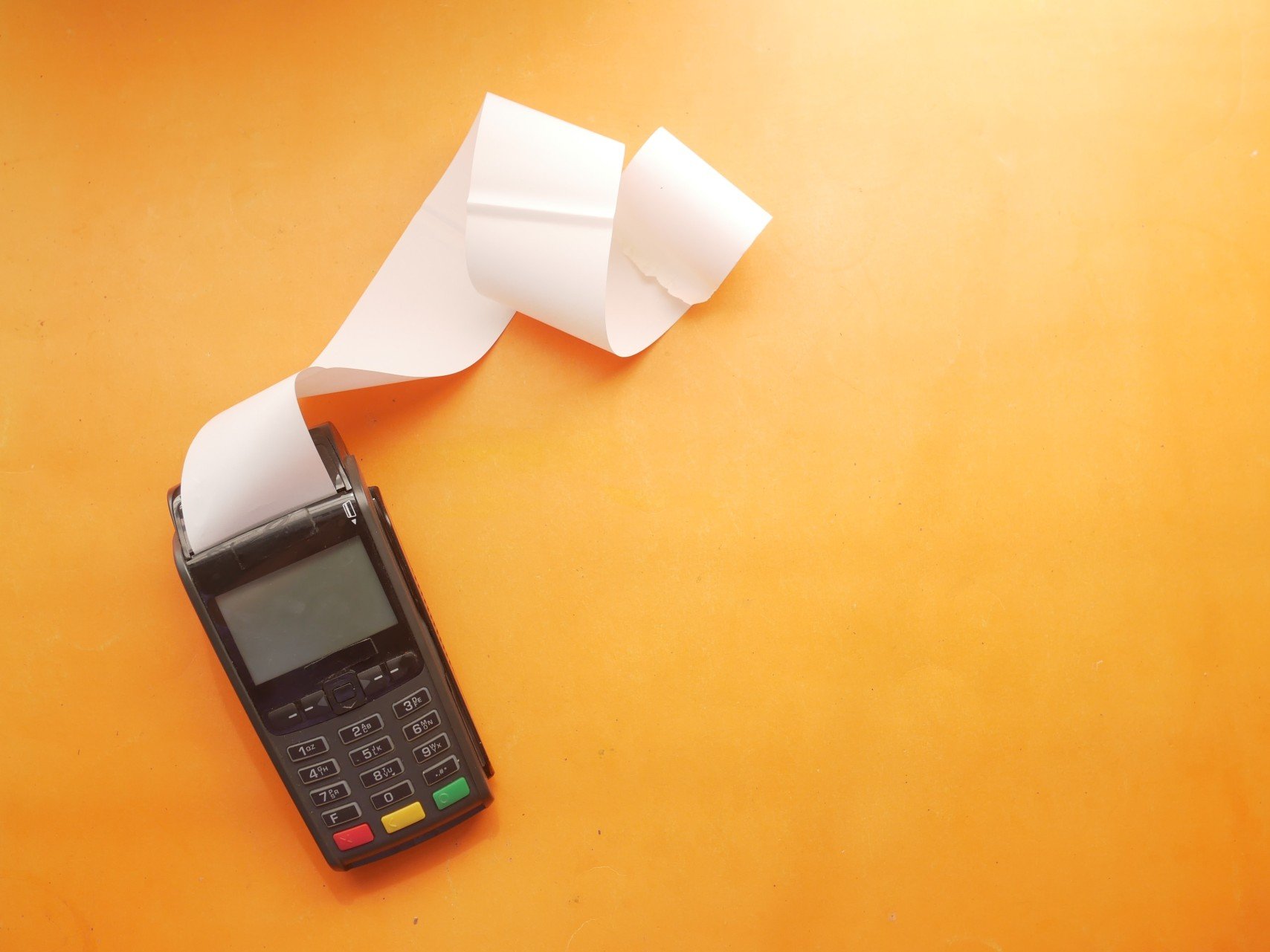 A card terminal printing a long receipt
